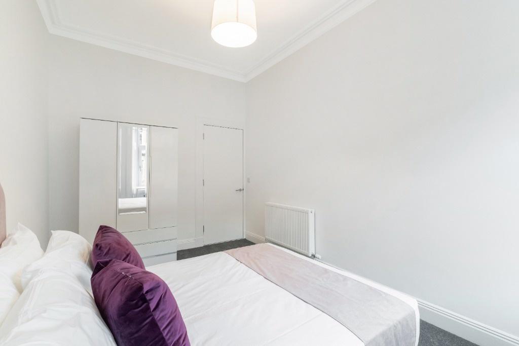 This inviting double bedroom features a comfort...