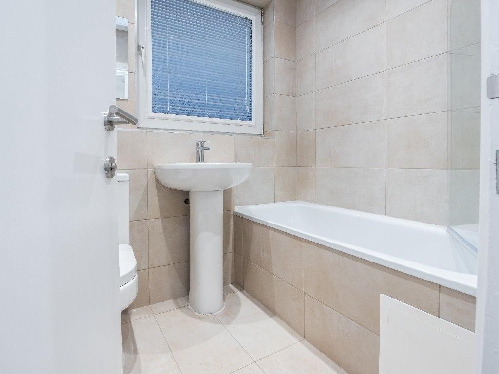 A modern bathroom featuring a clean design with...